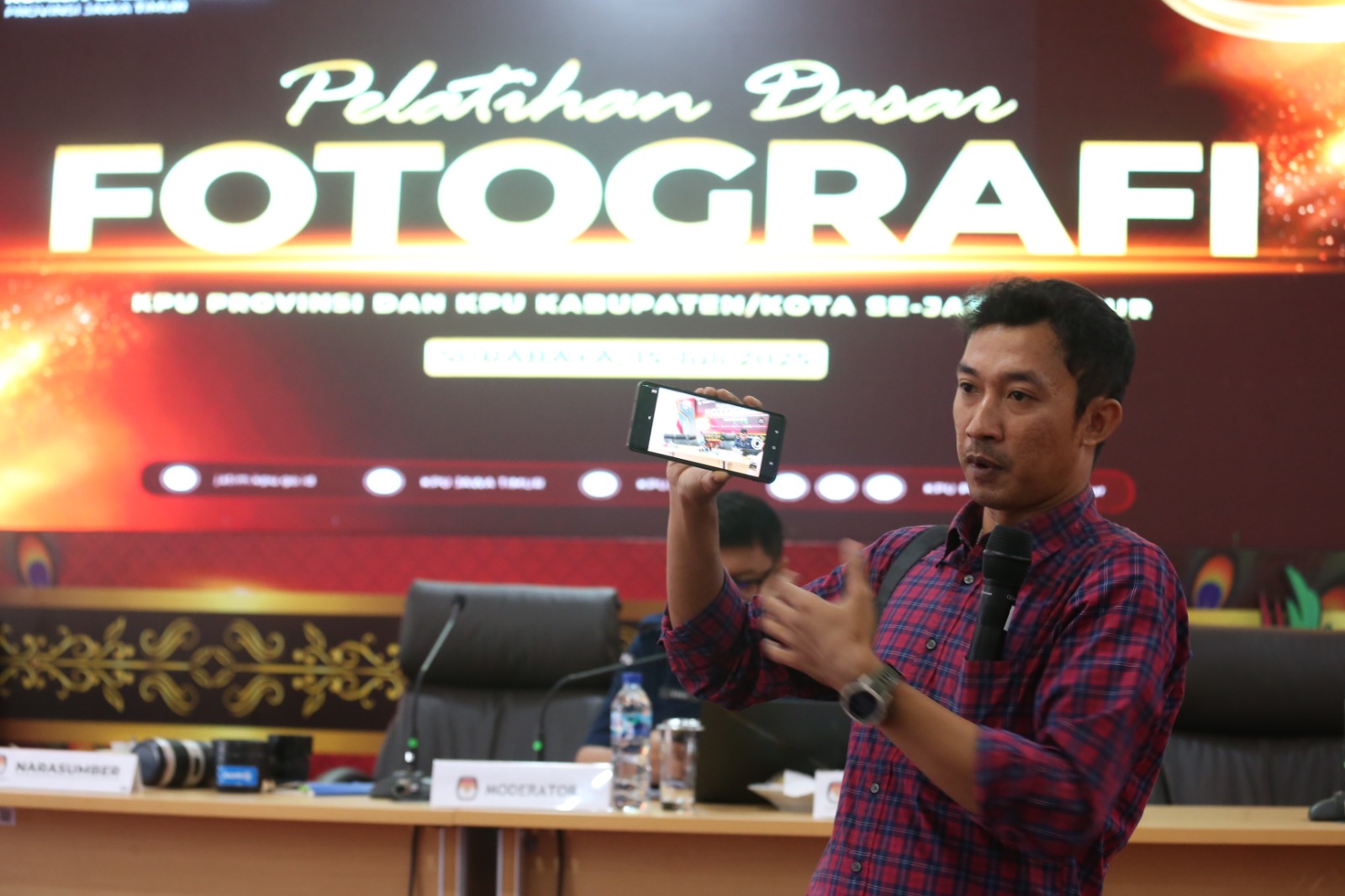 Robertus Riski, fotografer Tujuhpagi.com sedang menjelaskan teknik dasar fotografi dalam pelatihan yang diadakan oleh KPU Jawa Timur. Acara ini bertujuan untuk meningkatkan kemampuan dokumentasi visual para penyelenggara pemilu di era digital. (Sumber Fot
